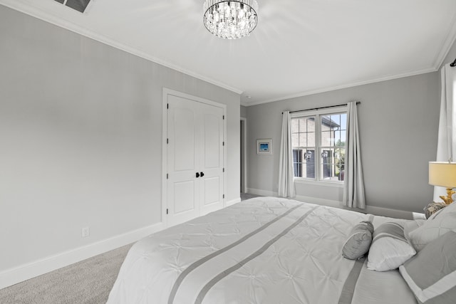 bedroom featuring ornamental molding, a closet, a chandelier, and carpet flooring