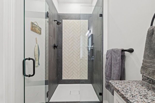 bathroom with vanity and a shower with door