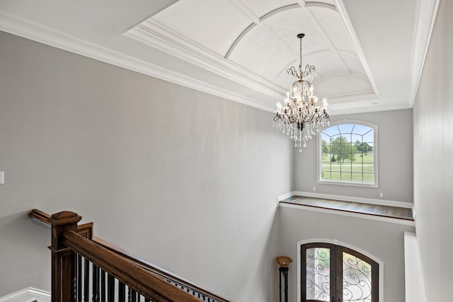 interior space featuring a tray ceiling, crown molding, and an inviting chandelier