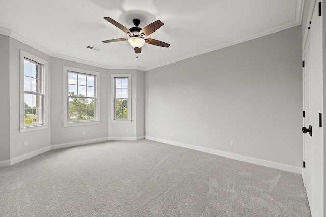 empty room featuring crown molding, light colored carpet, and ceiling fan