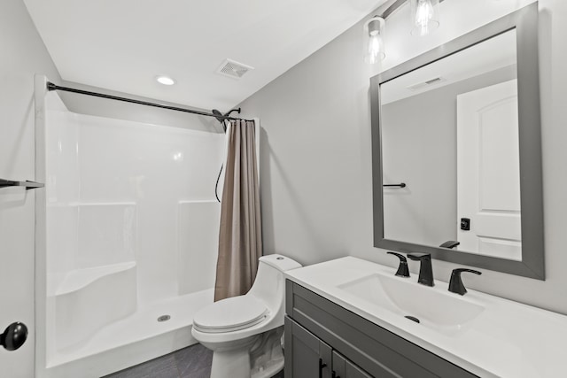 bathroom with a shower with curtain, toilet, and vanity