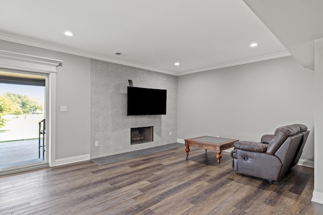 living room featuring a fireplace, dark hardwood / wood-style flooring, and ornamental molding