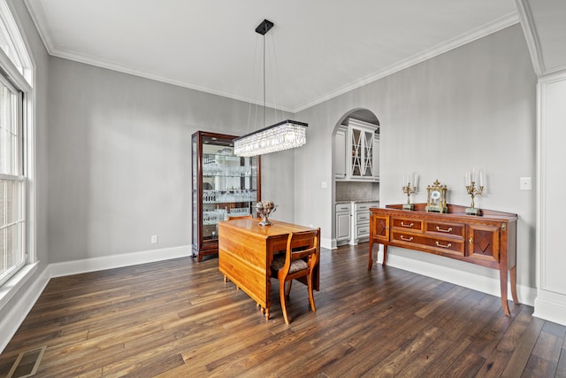 dining area featuring a wealth of natural light, dark hardwood / wood-style flooring, and crown molding