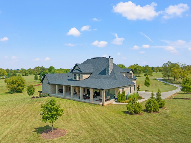 rear view of property with a yard