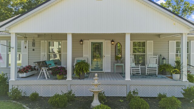 rear view of house featuring covered porch