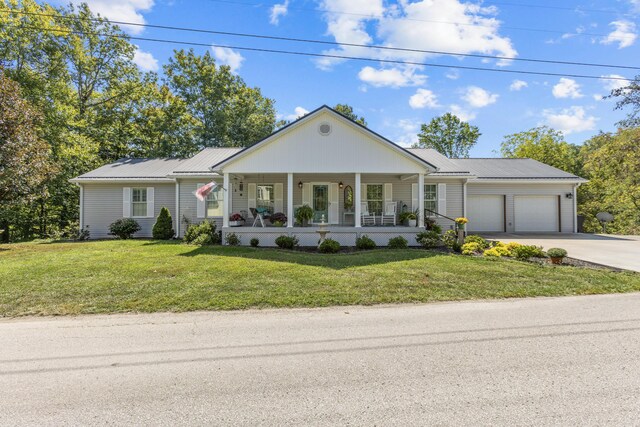 ranch-style home featuring a front yard, a garage, and a porch