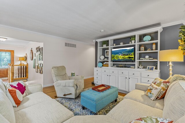 living room with ornamental molding and hardwood / wood-style flooring