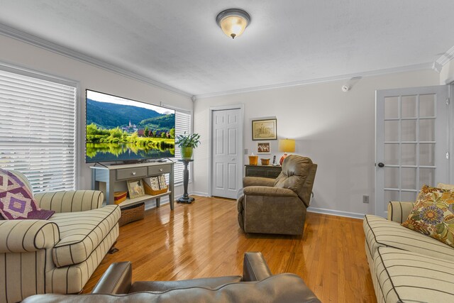 living room featuring light wood-type flooring and ornamental molding