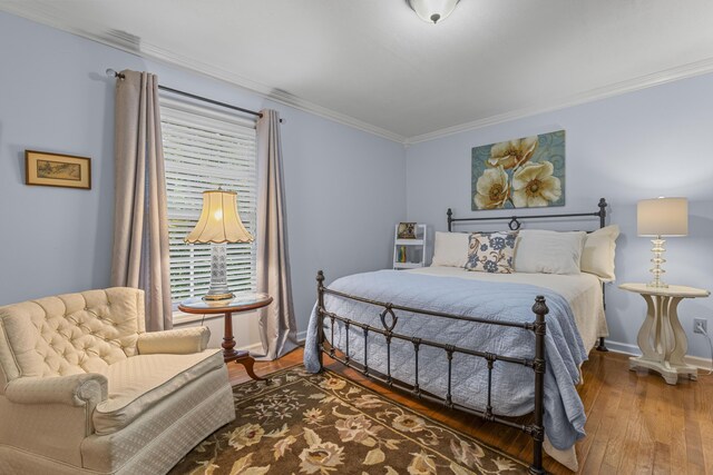 bedroom with wood-type flooring and crown molding