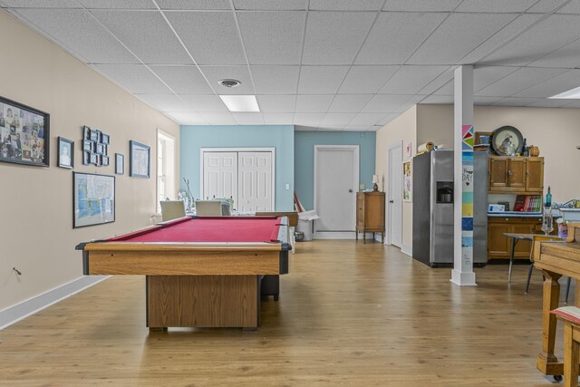 game room with light hardwood / wood-style flooring, pool table, and a paneled ceiling