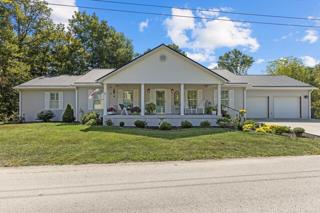 single story home featuring a front lawn, a porch, and a garage