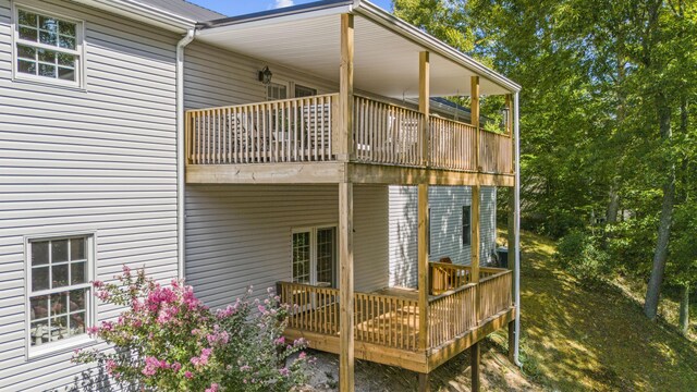 rear view of house featuring a wooden deck