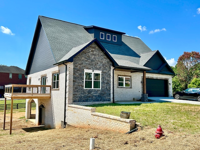 view of front of house featuring a wooden deck, a front yard, and a garage