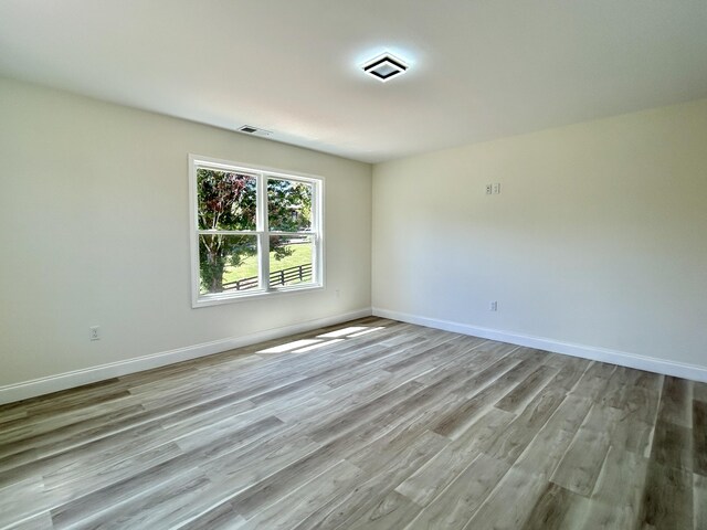 unfurnished room featuring light hardwood / wood-style floors