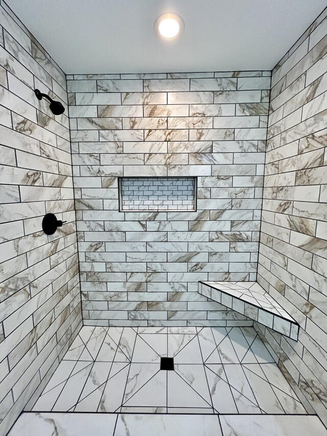 bathroom with tiled shower