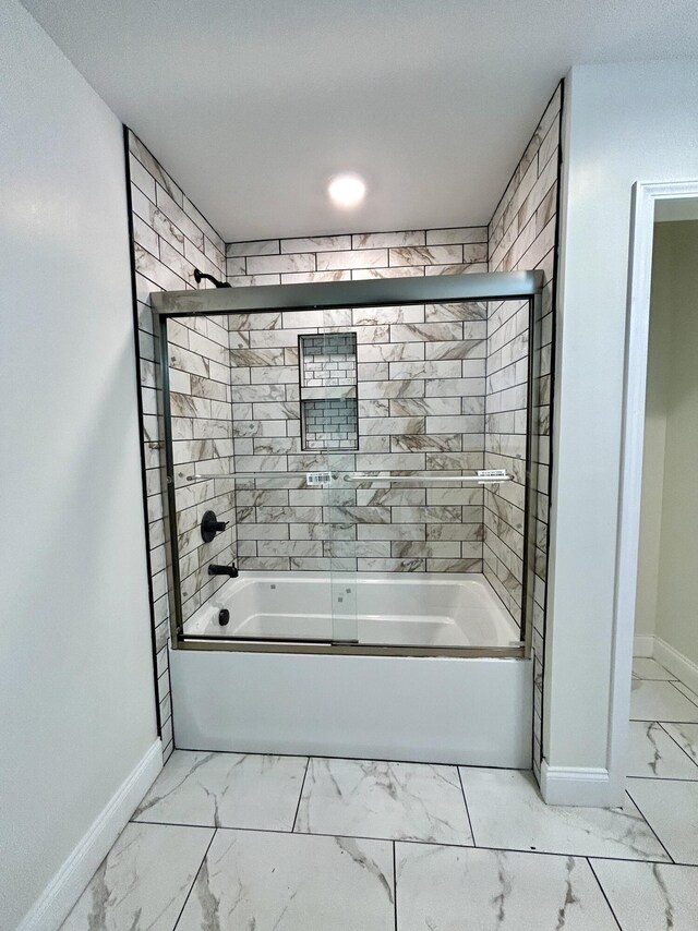 bathroom featuring bath / shower combo with glass door