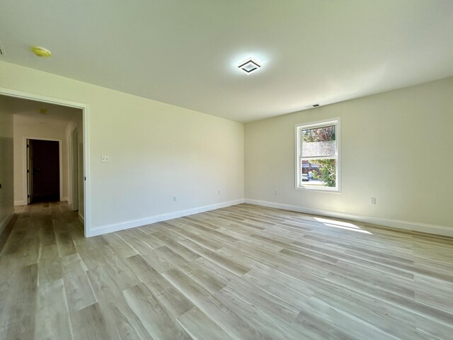 spare room featuring light hardwood / wood-style flooring