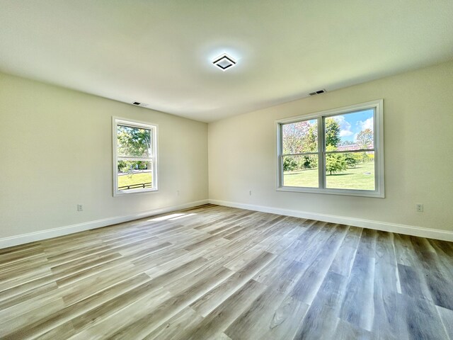 spare room with hardwood / wood-style flooring