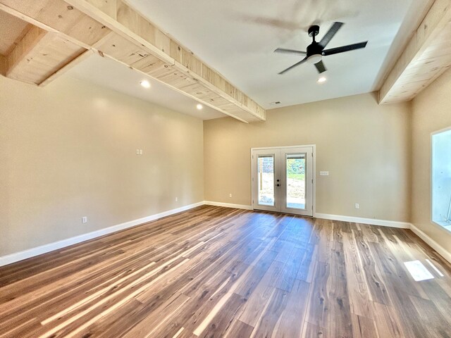 spare room with hardwood / wood-style floors, ceiling fan, beamed ceiling, and french doors