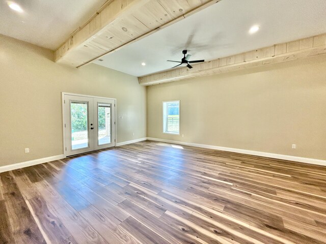 empty room with french doors, ceiling fan, beamed ceiling, and hardwood / wood-style flooring