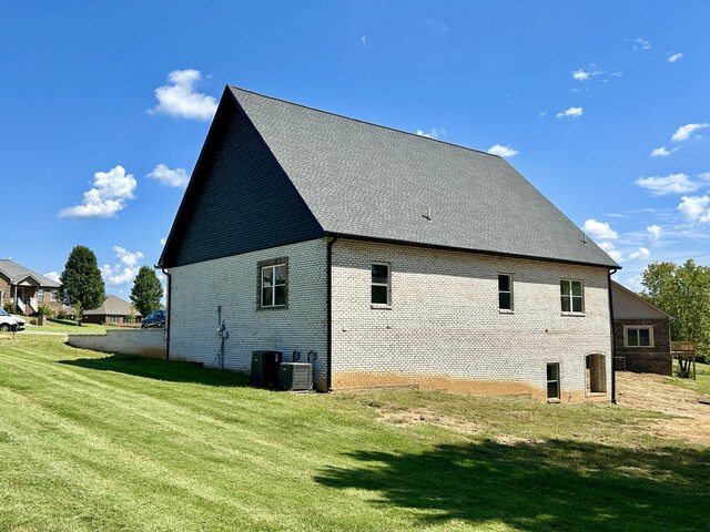 view of home's exterior featuring a yard and central air condition unit