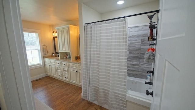 bathroom with shower / bath combination with curtain, vanity, and hardwood / wood-style floors