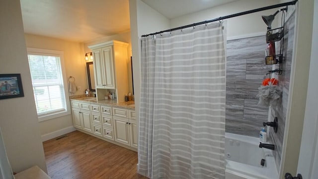 bathroom featuring shower / tub combo, vanity, and hardwood / wood-style floors