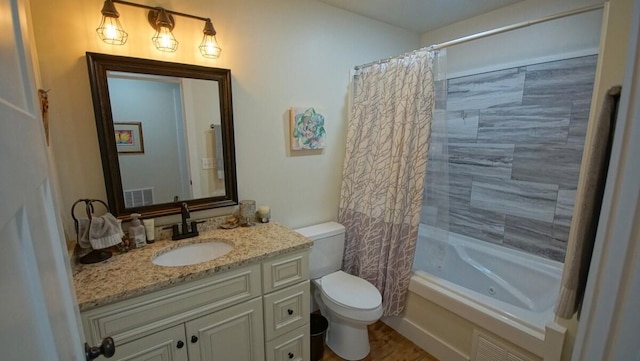 full bathroom with shower / bath combo with shower curtain, vanity, and toilet