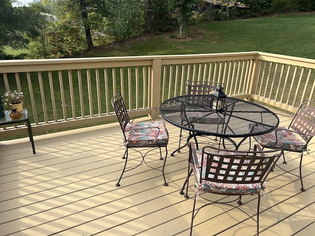 wooden deck featuring a lawn