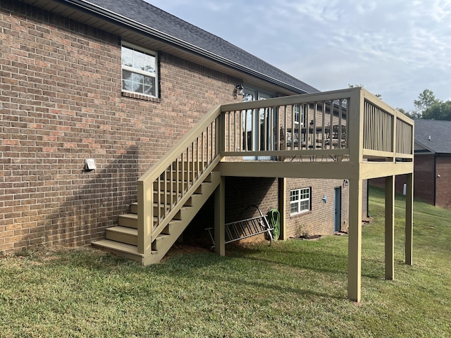 rear view of property with a deck and a yard