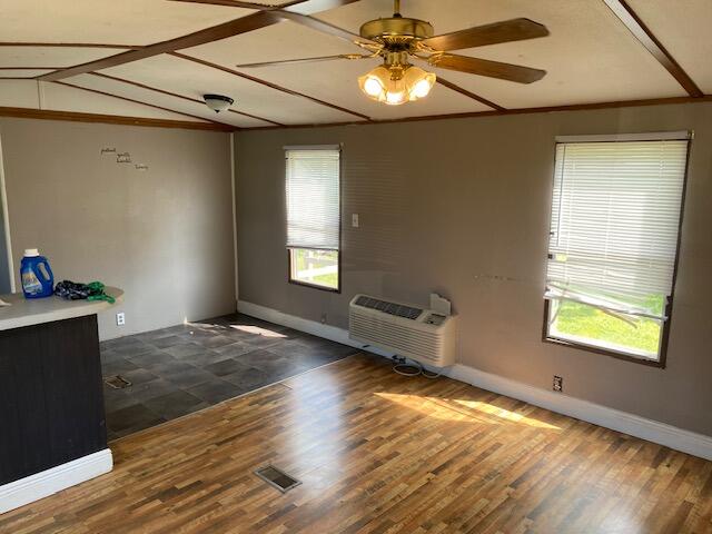 unfurnished room featuring lofted ceiling, dark hardwood / wood-style flooring, and ceiling fan