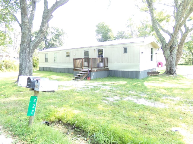 back of property with a lawn and a deck