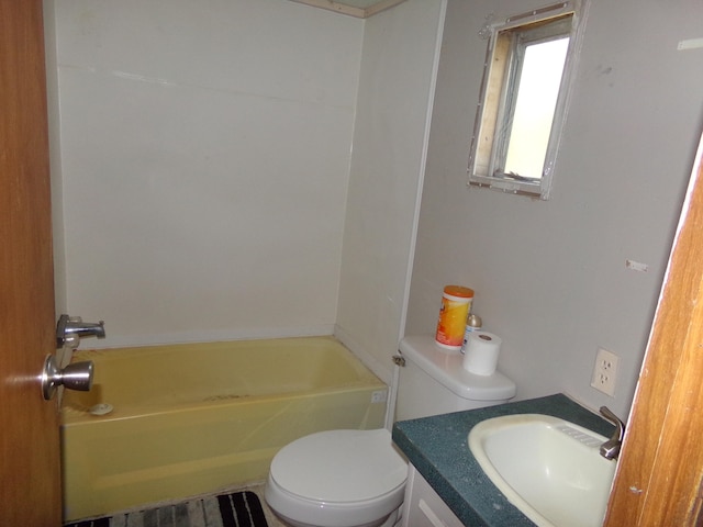 bathroom featuring vanity, a washtub, and toilet