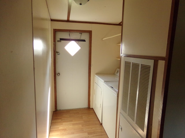 laundry room featuring light hardwood / wood-style floors and washing machine and clothes dryer