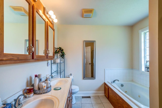 bathroom featuring tile patterned floors, a relaxing tiled tub, toilet, and vanity