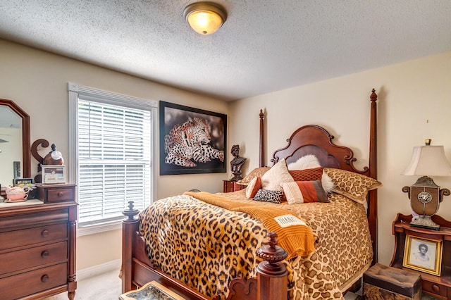 bedroom featuring light colored carpet, a textured ceiling, and multiple windows