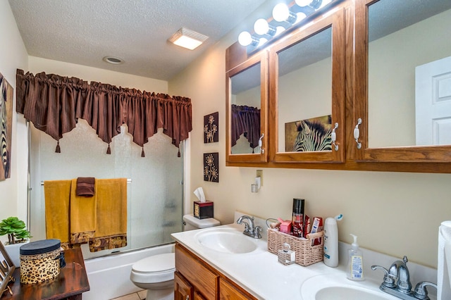 full bathroom with vanity, enclosed tub / shower combo, a textured ceiling, and toilet