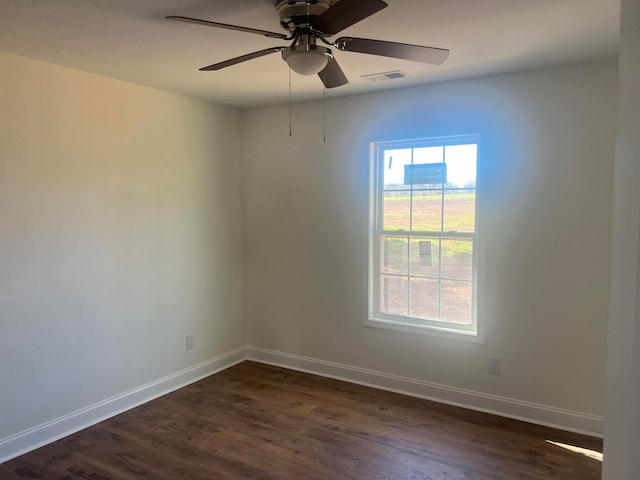 empty room featuring dark wood-type flooring and ceiling fan