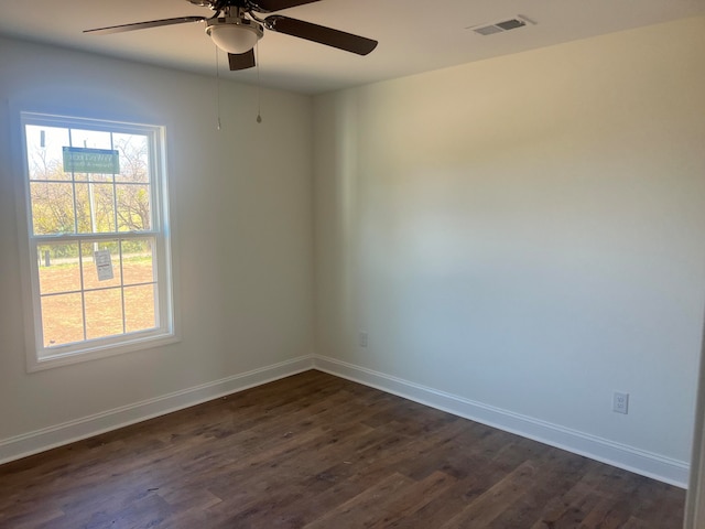 spare room featuring dark hardwood / wood-style flooring and ceiling fan