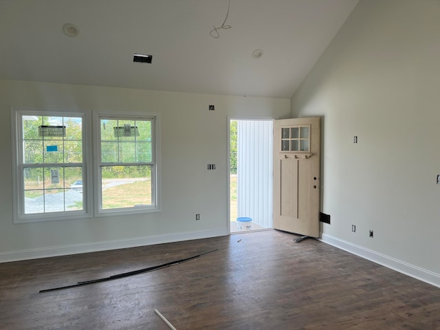 empty room featuring dark wood-type flooring and vaulted ceiling