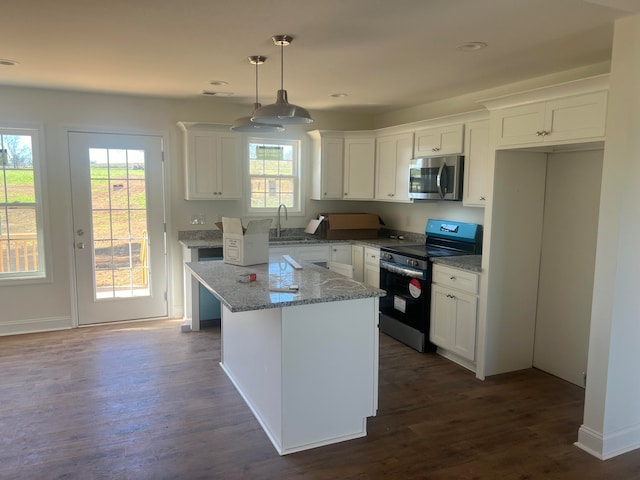 kitchen with white cabinetry, black range with electric cooktop, and a healthy amount of sunlight