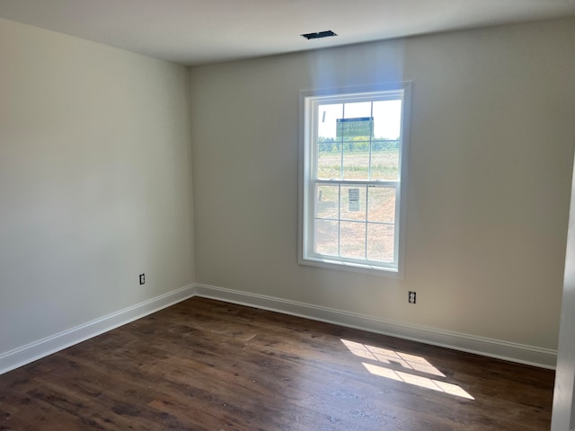 empty room with dark hardwood / wood-style floors