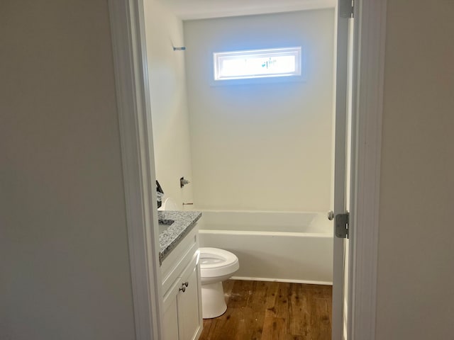 bathroom featuring toilet, vanity, and hardwood / wood-style flooring