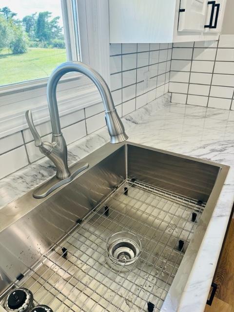 room details with white cabinetry and sink