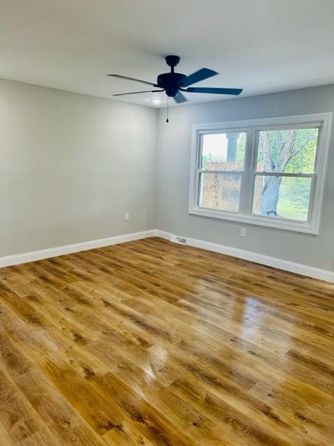 spare room with ceiling fan and hardwood / wood-style flooring