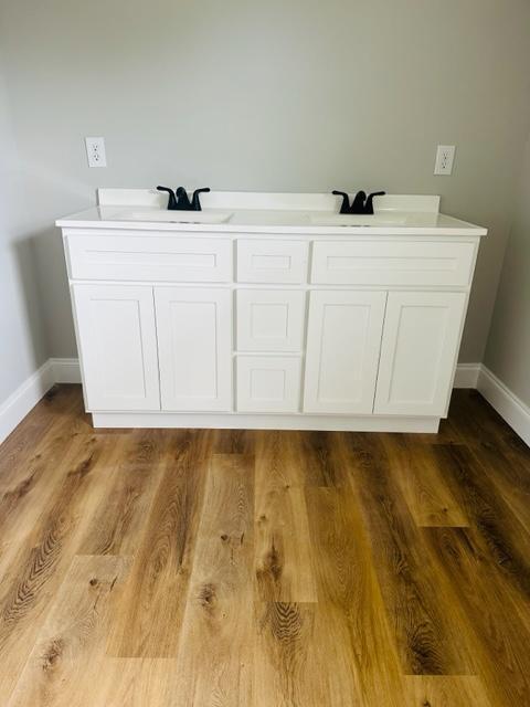 bathroom with hardwood / wood-style flooring and sink