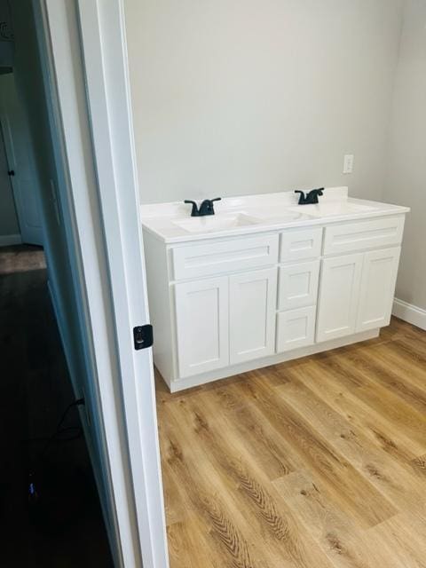 bathroom with vanity and hardwood / wood-style flooring