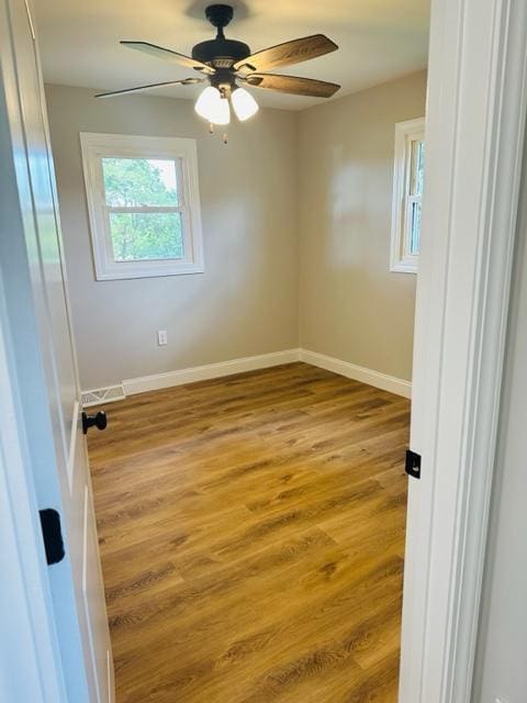 empty room with light hardwood / wood-style flooring and ceiling fan