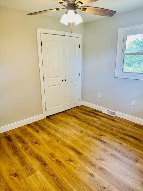 empty room featuring ceiling fan and wood-type flooring