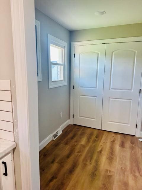 doorway to outside with wood-type flooring